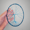 showing size of hoop resting in palm of adult female hand